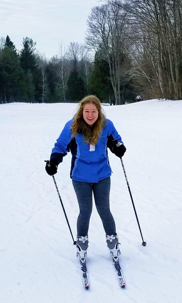 Emma smiling while on skiis
