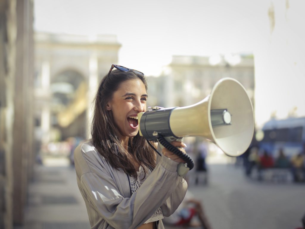 Women using her (blog) voice with a megaphone on the street